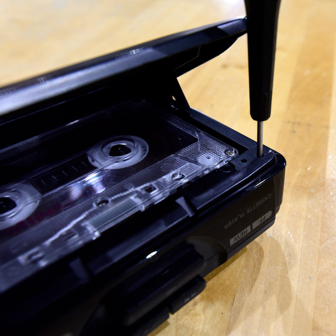 Can I adjust the tape speed (tuning) of my portable cassette player on my own?