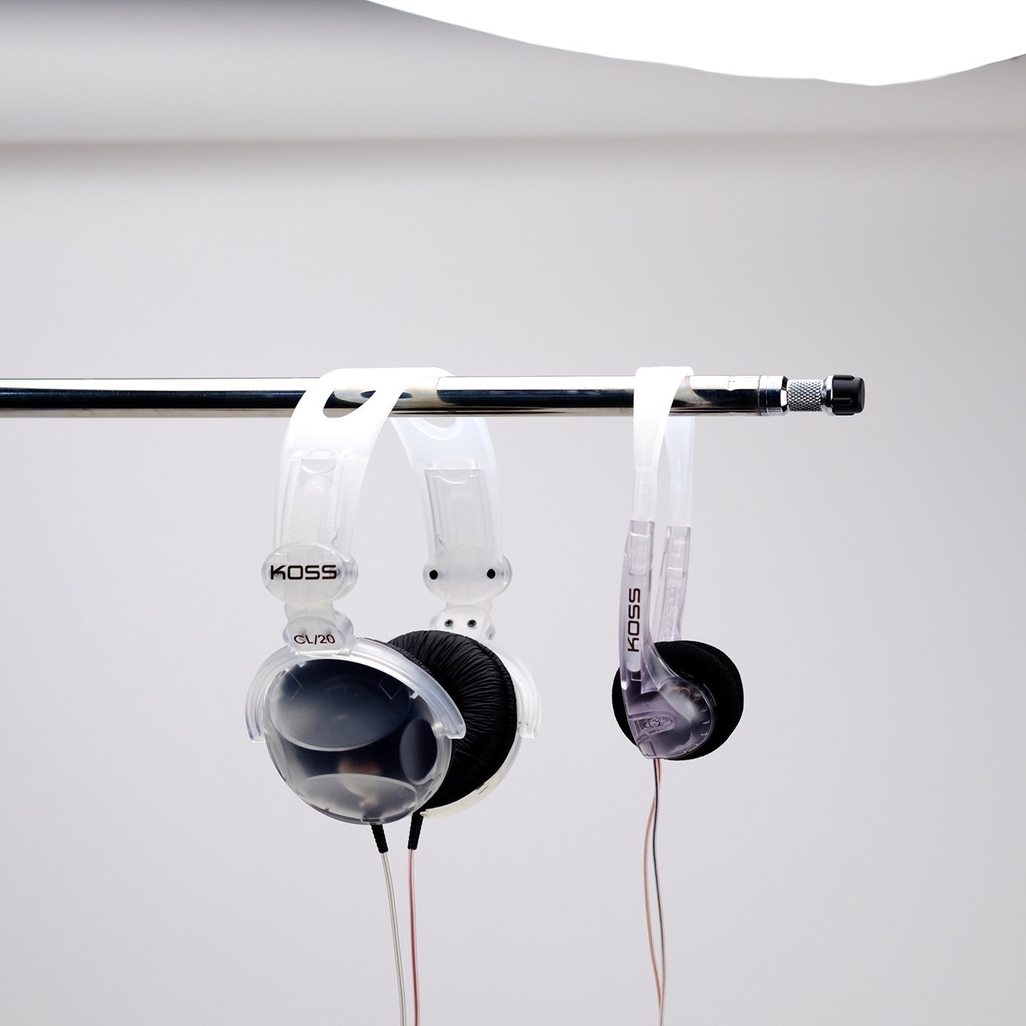Clear Koss headphones hanging on pole