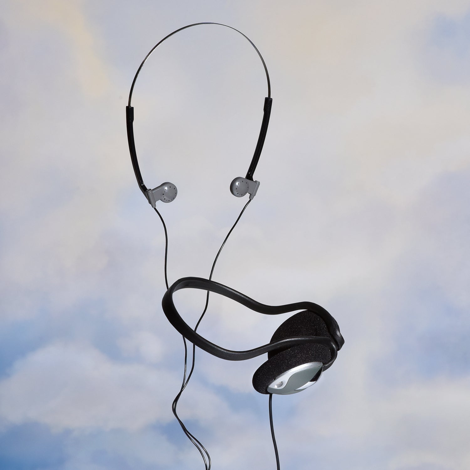 vintage headphones suspended in the sky