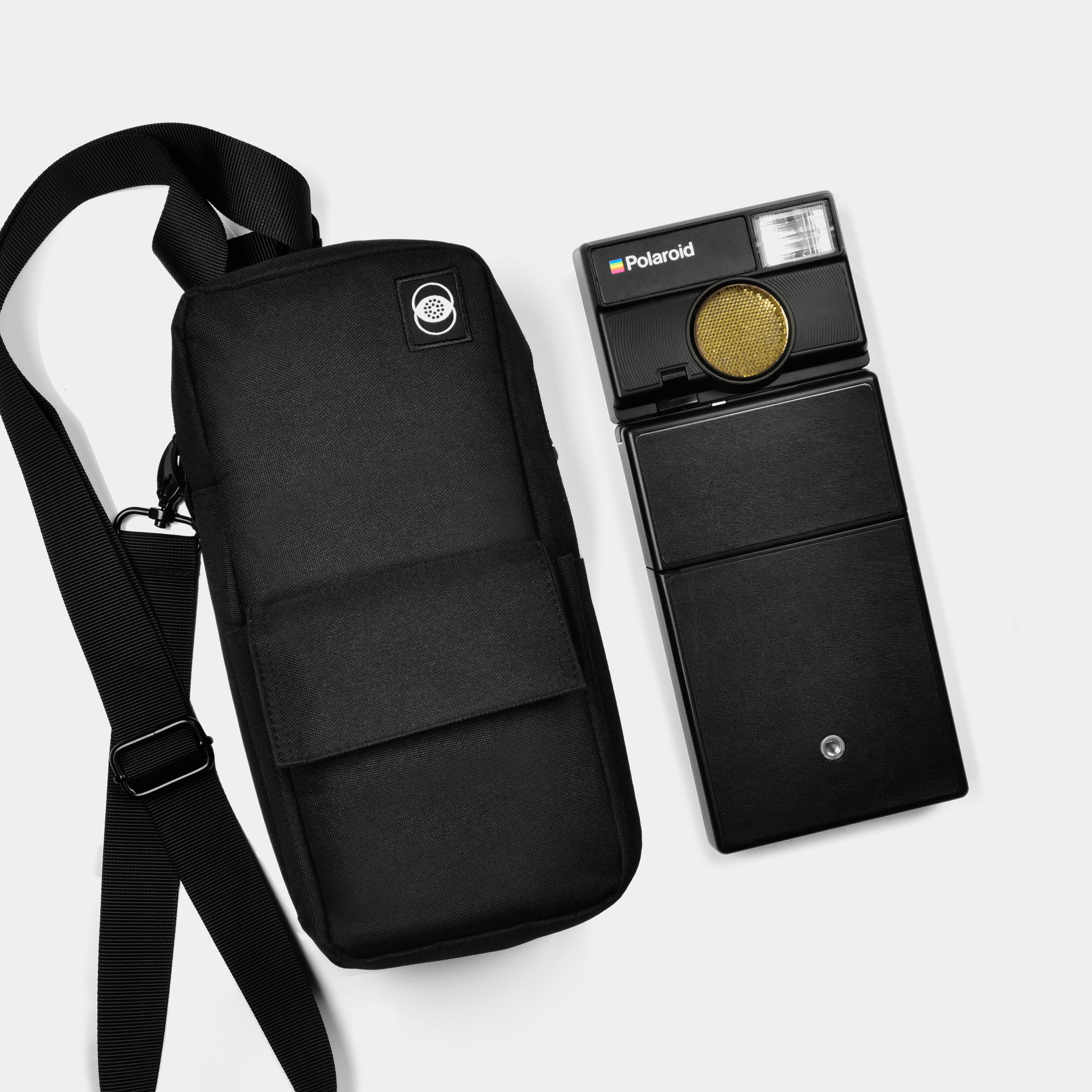 Retrospekt camera bag for Polaroid SLR 680 next to Polaroid SLR 680 camera